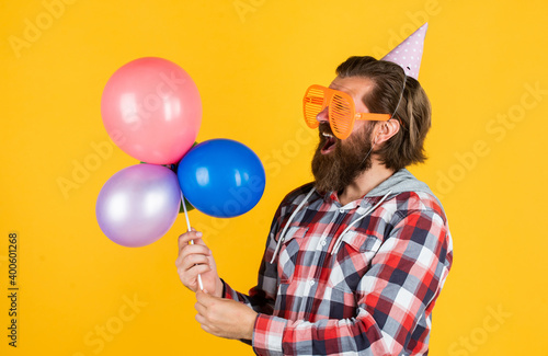 It is perfect. happy holiday celebration. party goer going crazy. having fun with balloons. prepare for anniversary. best event manager. brutal male on party. funny man in birthday hat photo