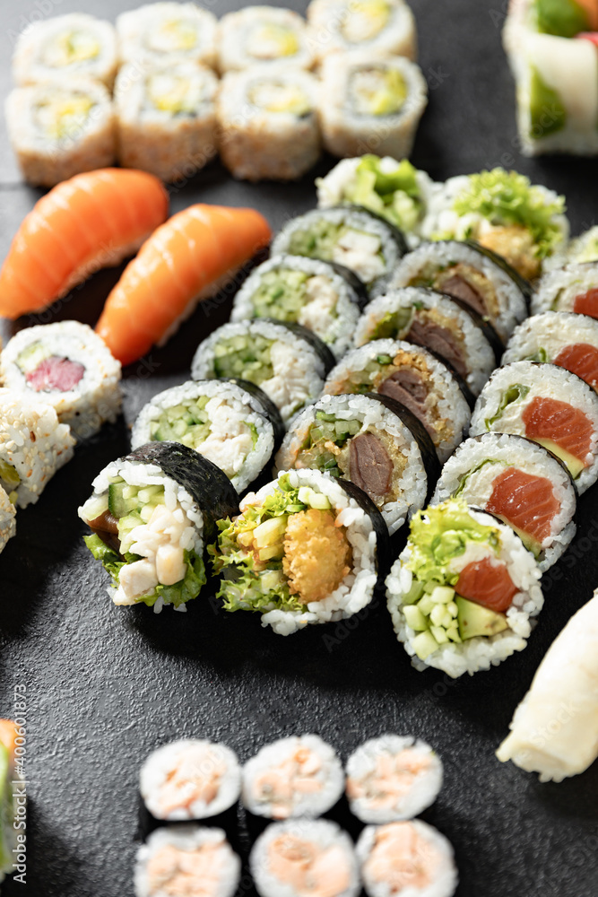 Sushi Rolls. Sushi Rolls Set, maki, philadelphia and california rolls, on a Black background. Sushi Rolls. Sushi Rolls Set, maki, philadelphia and california rolls, on a Black background.