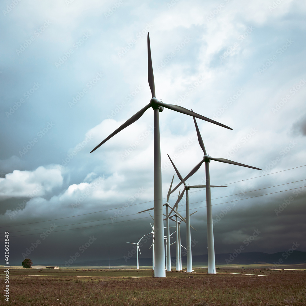 Wind turbines generating electricity in a stormy weather. Wind turbines generating electricity in a stormy weather.