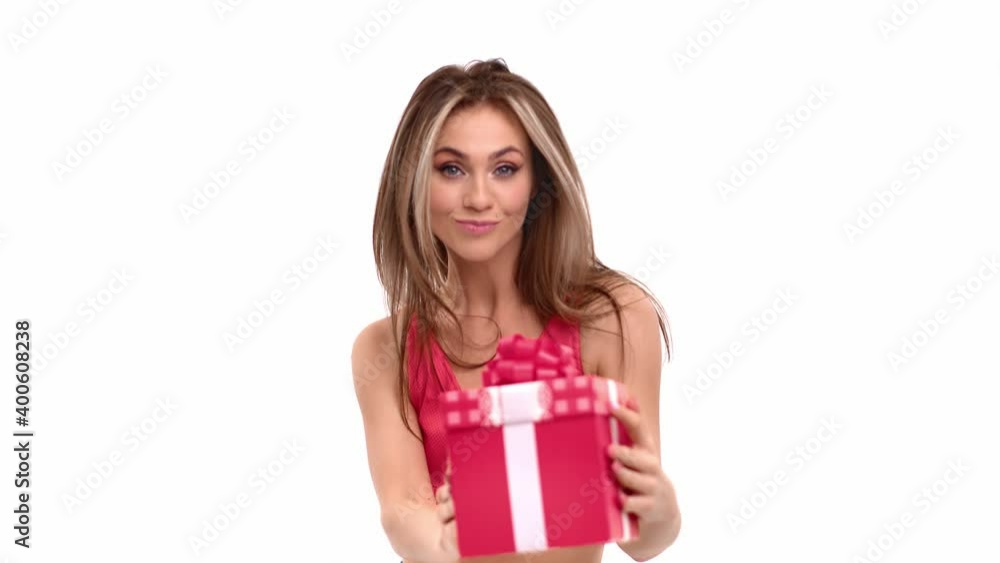 Playful woman smiling with red gift box celebrating holiday. Shot on RED Raven 4k Cinema Camera Playful woman smiling with red gift box celebrating holiday. Shot on RED Raven 4k Cinema Camera