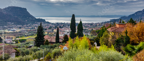 Garda seen from above. The town is located in the center of the homonymous gulf, which in part stretches to form a small peninsula, which includes Punta San Vigilio and the Baia delle Sirene. photo