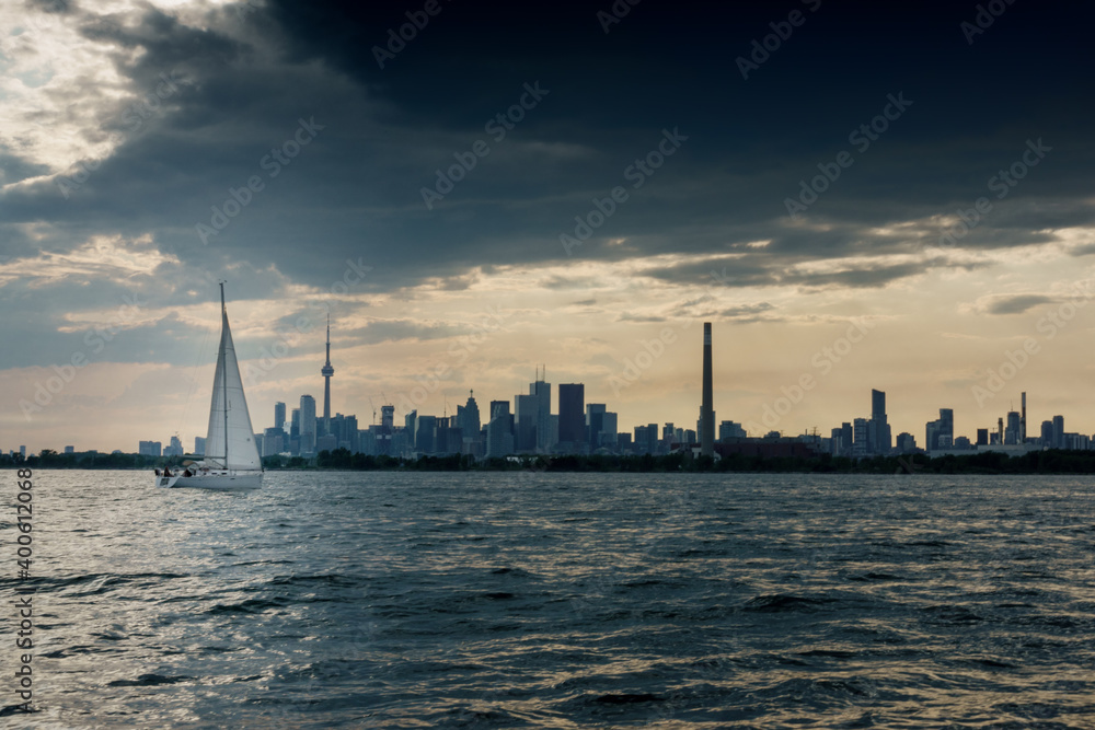 Sailboat in lake with toronto skylines under sky