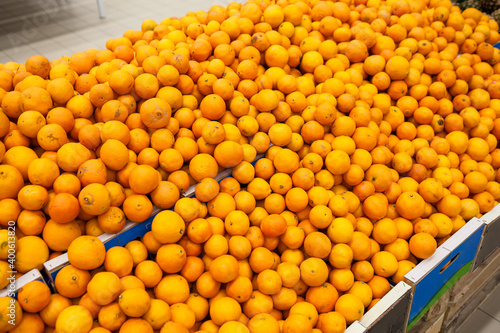 Orange mandarins are in sale in supermarket stalls