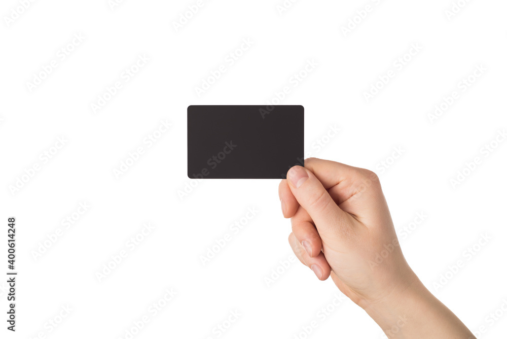 Cropped close up photo image of female hand giving you blank black credit card isolated white color background Cropped close up photo image of female hand giving you blank black credit card isolated white color background