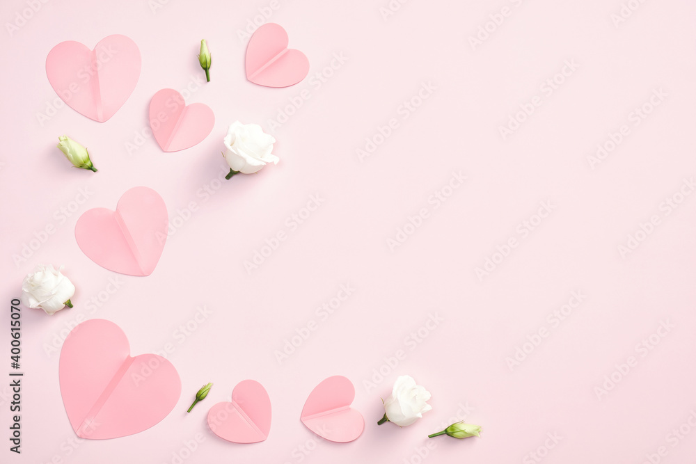 Happy Valentines Day concept. Flat lay paper hearts and white rose flowers on pink background. Top view with copy space.