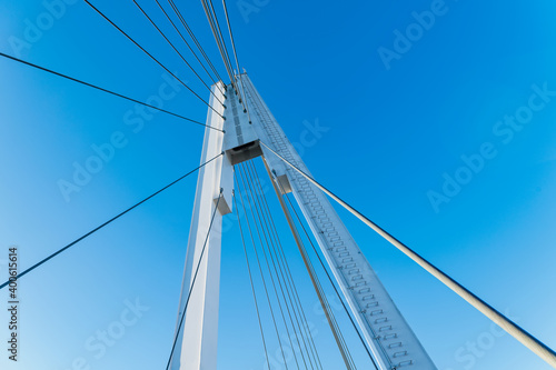 Details of the cable-stayed bridge against the background of the blue sky.
