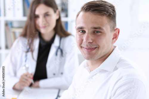 Wallpaper Mural Satisfied happy handsome smiling male patient with doctor at her office. High level and quality medical service, therapeutist consultation, work and career, physical, healthy lifestyle concept Torontodigital.ca