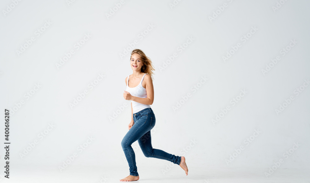woman jumped up on a light background in full growth sport fitness woman jumped up on a light background in full growth sport fitness