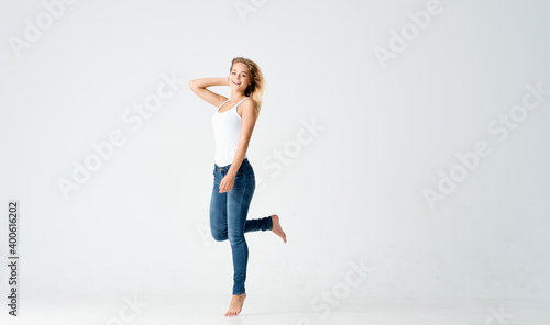 woman jumped up on a light background in full growth sport fitness