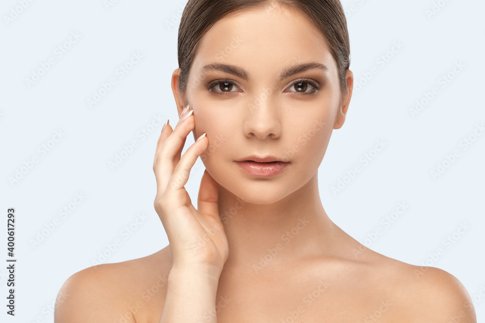 Portrait of a beautiful brunette girl with healthy clean skin and fresh make-up. Aesthetic cosmetology and makeup concept.