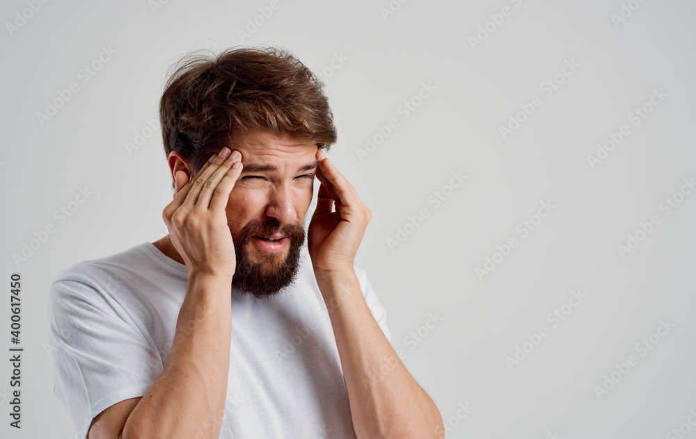 bearded man holding his head discontent health problem disorder