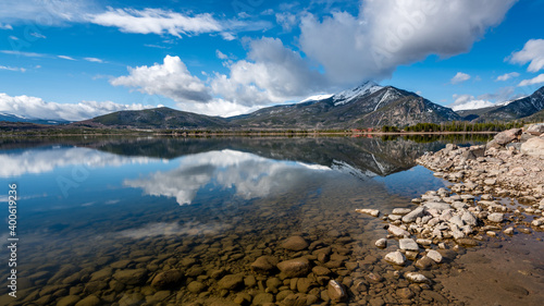 Still water lake Dillon in Colorado with mountain and cloud reflections photo