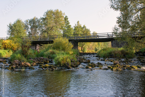Wooden bridge over the river in summer day