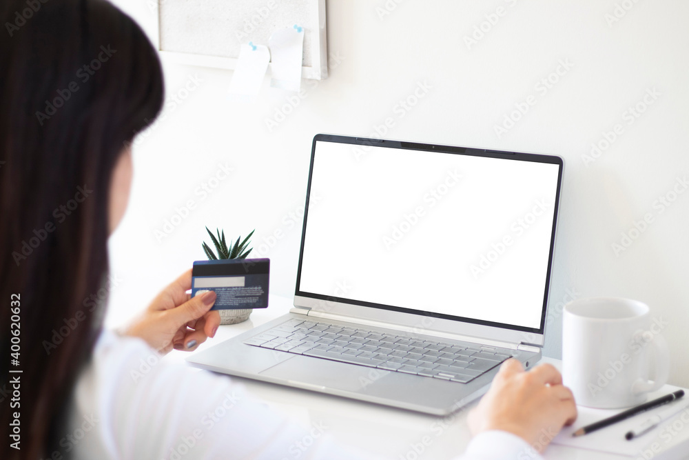 woman hands holding a credit card while using mockup image blank screen laptop. online shopping and payment woman hands holding a credit card while using mockup image blank screen laptop. online shopping and payment