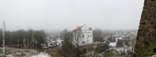 Panorama of tower Shchitovka and the church tower. Ruins of Mindovg Castle on Castle Hill. Farnese Church of Transfiguration of the Lord in the background. Novogrudok. Belarus. Travel concept. photo