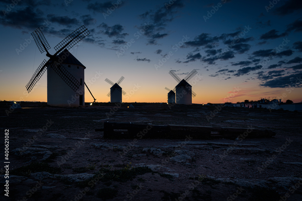 Exterior view of windmills on landscape in spring in Campo de Criptana at sunrise, Ciudad Real, Spain