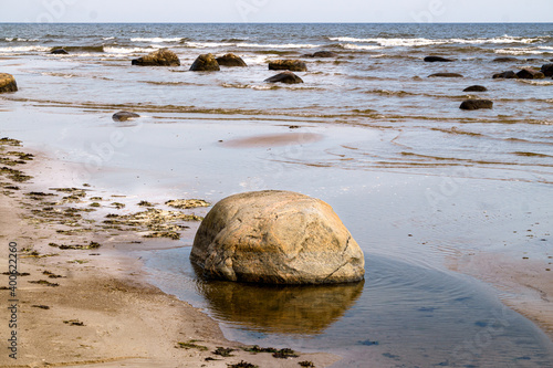Large stone boulders on the shore of the Gulf of Riga on a summer day.