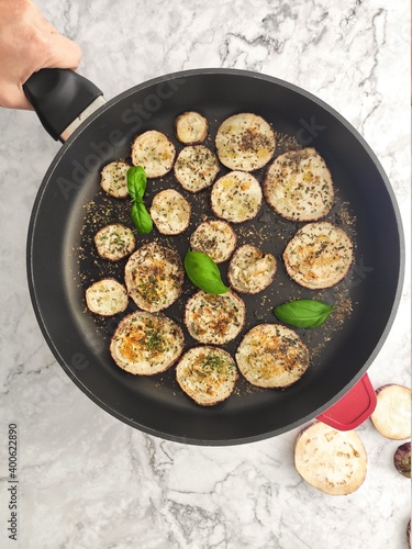 Grilled sliced aubergines with fresh basil and dried herbs