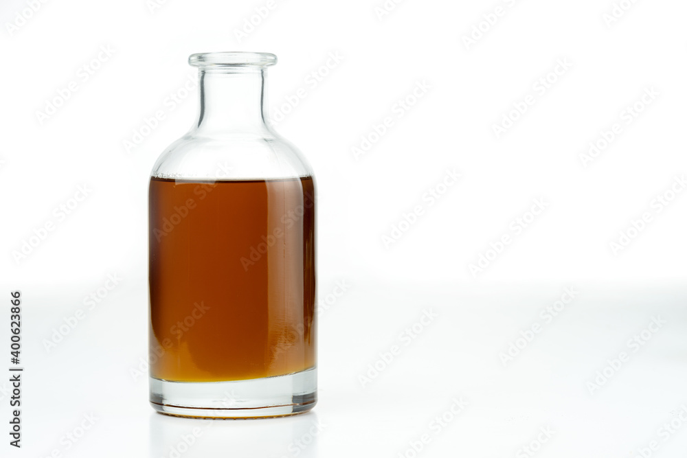 Vegetable oil in a glass bottle. Isolated on a white background. Vegetable oil in a glass bottle. Isolated on a white background.