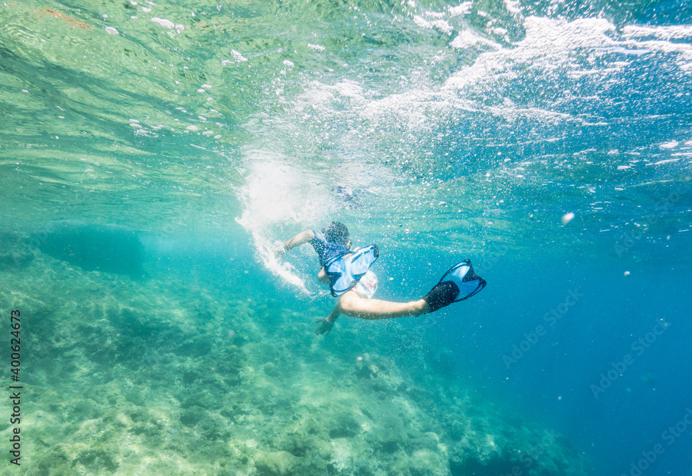 Boy swimming underwater