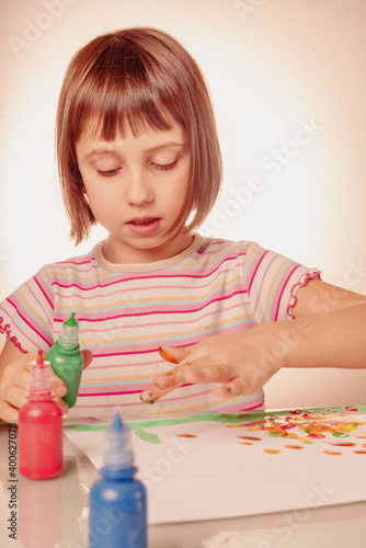 Art and fun leisure time concept. Beautiful young girl great artist painting picture with hands. Vertical image.