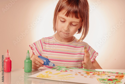 Art and fun leisure time concept. Beautiful young girl great artist painting picture with hands. Horizontal image.