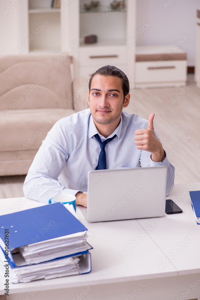 Young male employee working from home in pandemic concept Young male employee working from home in pandemic concept
