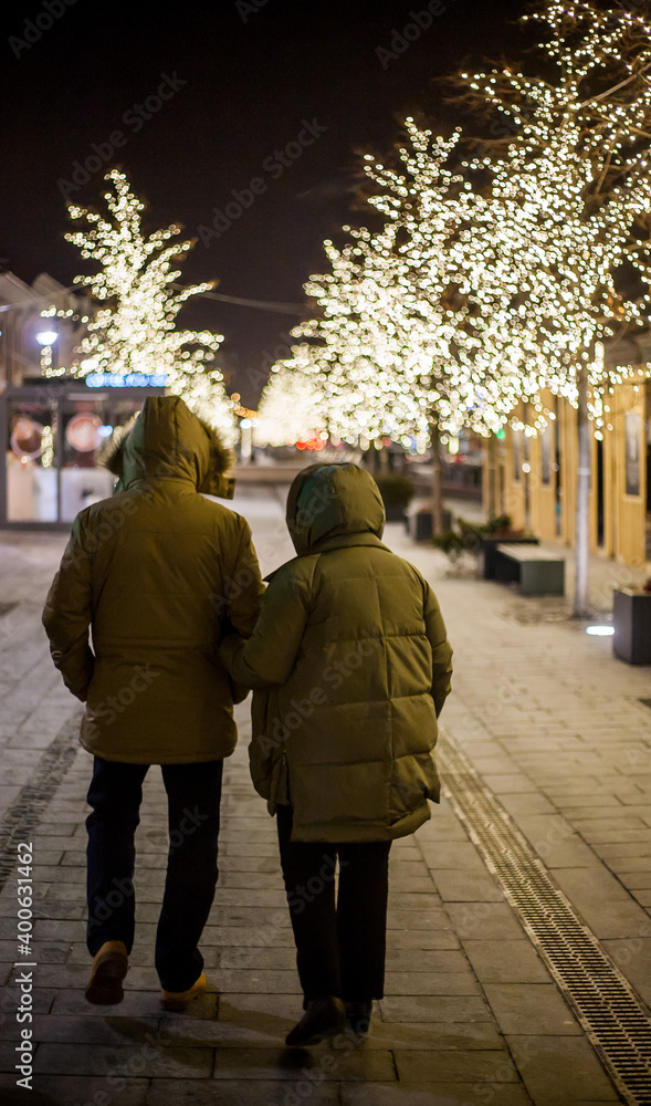 people walking on the street at night people walking on the street at night