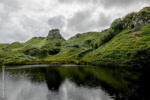 The small pond and reflected rocks of Faerie Castle (Castle Ewen) at the Fairy Glen in Isle of Skye, Scotland