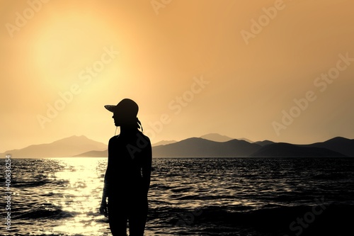 Young Woman Profile Silhouette with hat on the Beach