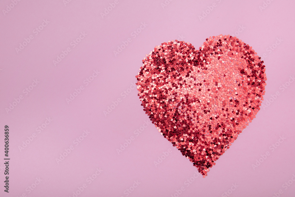 Heart shape made of red glitter on pink background. Love concept. Heart shape made of red glitter on pink background. Love concept.