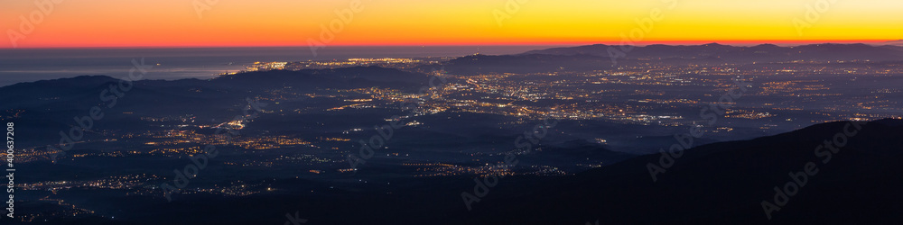 Barcelona aerial view at dusk with the lights of the city in the away. Beautiful panoramic cityscape of the city of Barcelona from Montseny, Turo de l'Home, Catalunya-Catalonia.