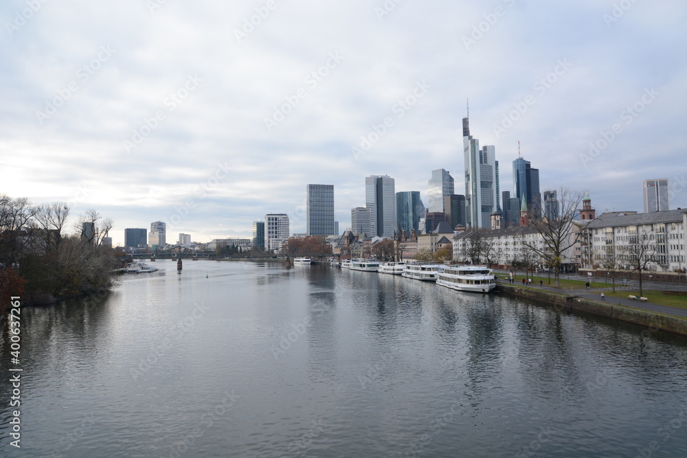 Fototapeta premium View on Frankfurts Skyline, seen from a bridge over the river Main