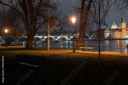 .light from street, lights and a pedestrian chopper and grass at night in a park in the Czech Republic