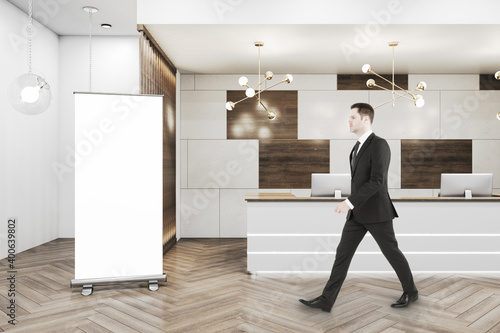 Businessman walking in office hall