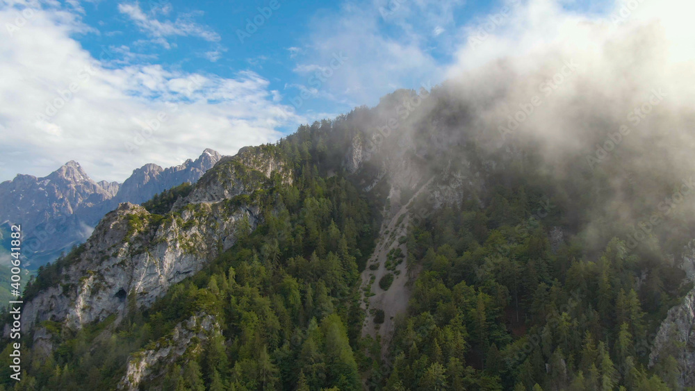 AERIAL: Breathtaking view of the beautiful Julian Alps on a sunny summer day.