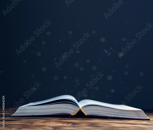 Opened book on wooden table