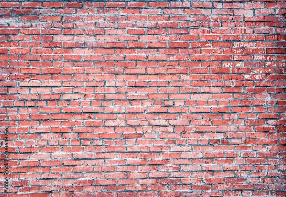Naklejka premium The wall, made of old red bricks, darkened by old age. Ancient vintage brick wall background. Brick wall backdrop