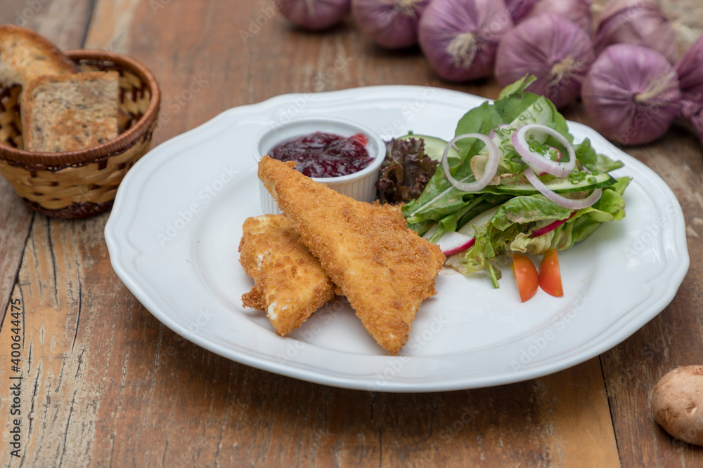 Baked feta cheese served with mixed salad and cranberry jam Baked feta cheese served with mixed salad and cranberry jam