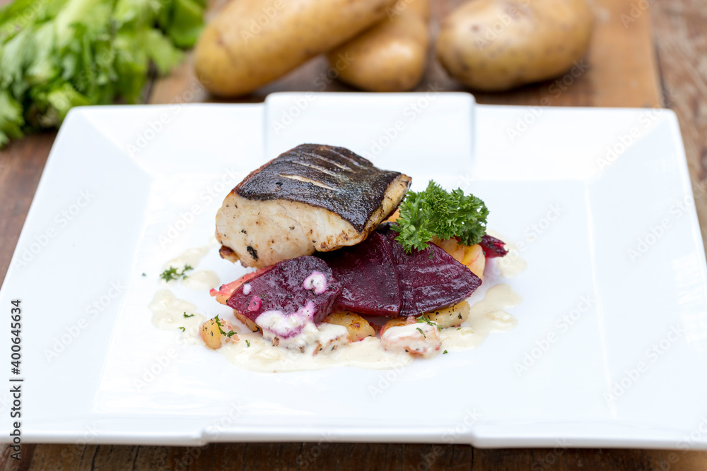 Pan-fried black cod on sautéed beetroot and potatoes with horseradish cream Pan-fried black cod on sautéed beetroot and potatoes with horseradish cream