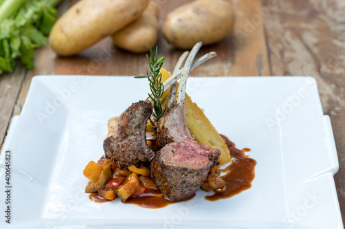 Grilled Australian lamb rack on ratatouille with potato gratin and Madeira jus photo