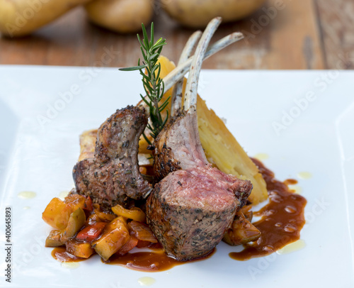 Grilled Australian lamb rack on ratatouille with potato gratin and Madeira jus photo