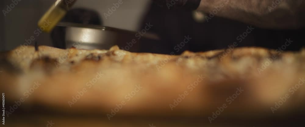 Italian chef spreading olive oil with brush over traditional al taglio pizza. Close up, slow motion Italian chef spreading olive oil with brush over traditional al taglio pizza. Close up, slow motion