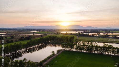 Panoramic view from rice fields of fantastic landscape of dramatic colorful sky. © Chaiwat