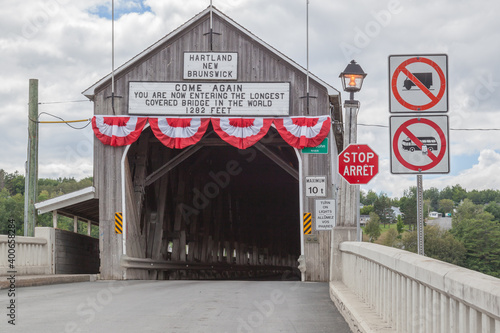 NEW  BRUNSWICK, CANADA - August 6, 2017: Entrance of of Hartland covered  bridge in New Brunswick. This 390-m (1,282-ft.) bridge opened on 1901, the longest wooden covered bridge in the world. 