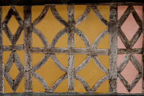 Timber frame pattern with colorful painted wattle and daub in an historic Tudor building Faversham Kent England.
