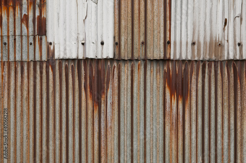 Wall of old rusted corrugated iron sheeting.