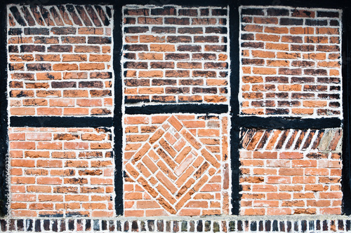 Brickwork and black timber frame pattern in an historic Tudor building Faversham Kent England.