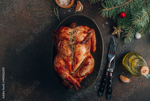 Baked chicken or turkey on a festive table with Christmas decoration. New year and Christmas concept.