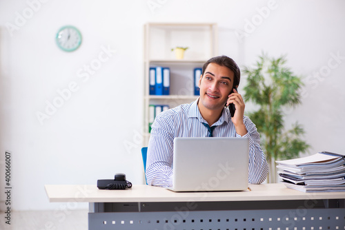 Young male employee working in the office